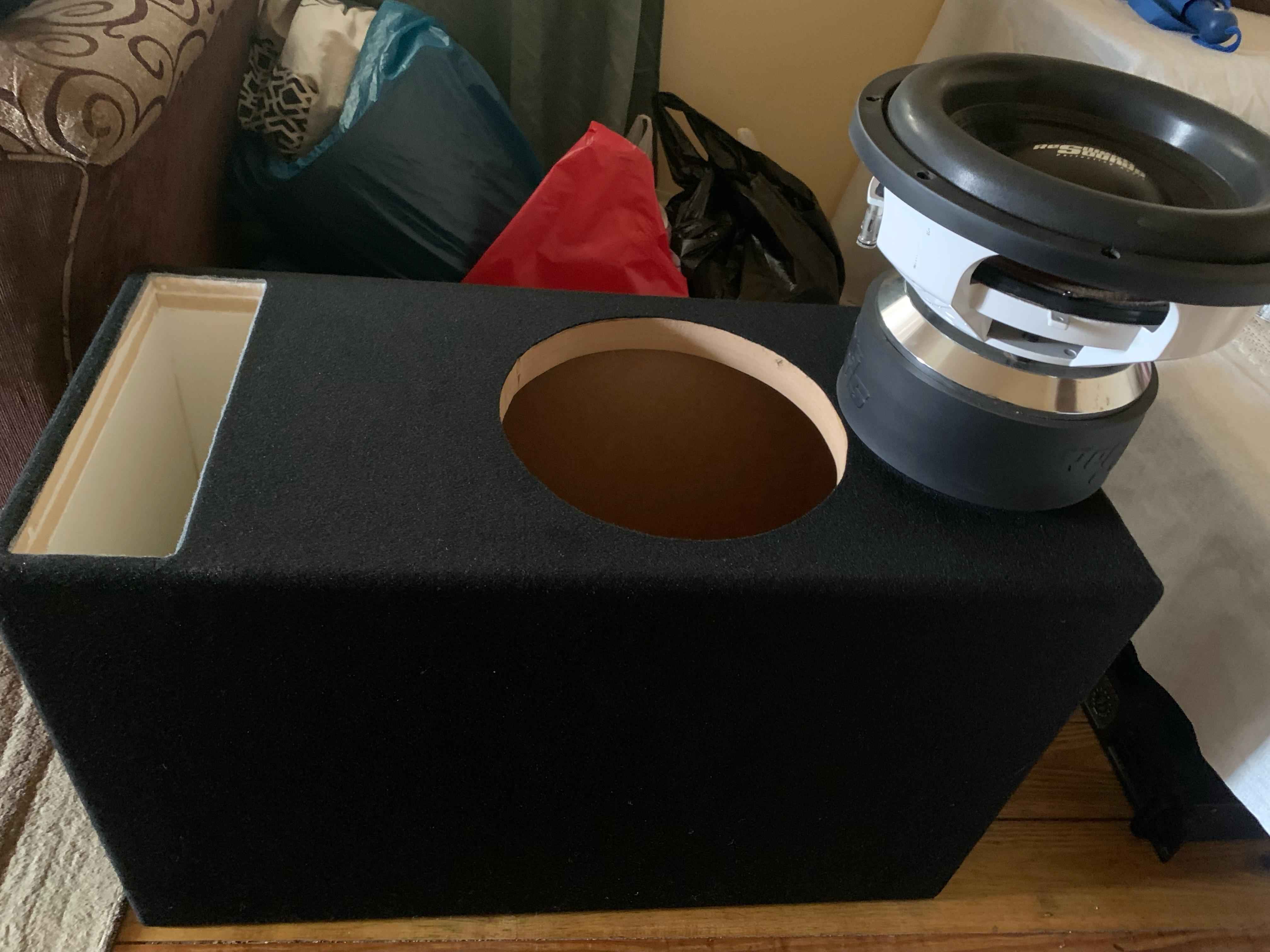 Ported enclosure with free-air subwoofer during bench fitment